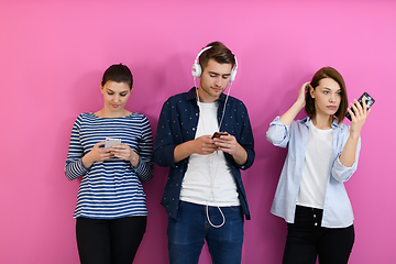 Image showing group of friends have fun and dance while using a cell phone and headphones