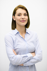 Image showing Portrati shot of beautiful blond businesswoman standing with arms crossed at isolated white background.