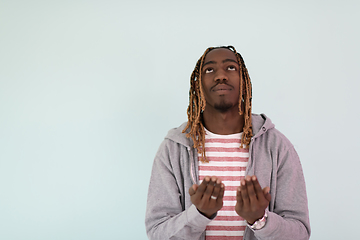 Image showing Young African Muslim Man Making Traditional Fatiha Prayer To Allah