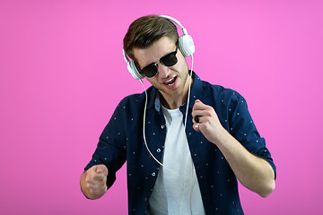 Image showing guy wears glasses and headphones while dancing and having fun