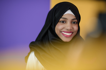 Image showing muslim woman with a beautiful smile wearing a hijab poses in the studio
