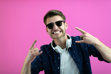 Image showing guy wears glasses and headphones while dancing and having fun