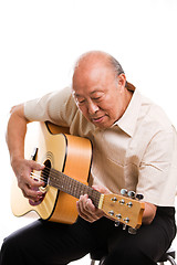 Image showing Senior asian playing guitar