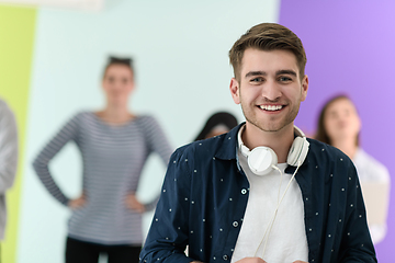 Image showing guy with the beautiful smile in the blue attractive shirt i use my cell phone and headphones