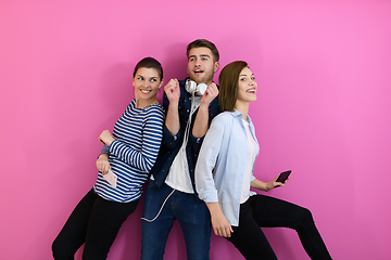 Image showing group of friends have fun and dance while using a cell phone and headphones