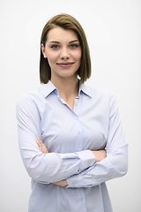 Image showing Portrati shot of beautiful blond businesswoman standing with arms crossed at isolated white background.