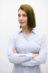 Image showing Portrati shot of beautiful blond businesswoman standing with arms crossed at isolated white background.