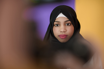 Image showing muslim woman with a beautiful smile wearing a hijab poses in the studio