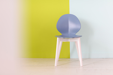 Image showing modern blue chair in front of a blue green background