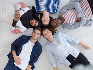 Image showing top view of a diverse group of people lying on the floor and symbolizing togetherness