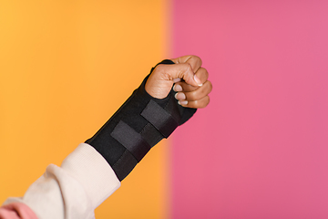 Image showing hand injury. a female injured hand on a yellow background