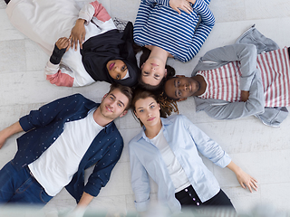 Image showing top view of a diverse group of people lying on the floor and symbolizing togetherness