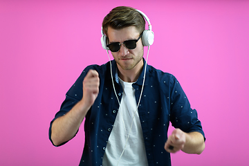 Image showing guy wears glasses and headphones while dancing and having fun