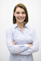 Image showing Portrati shot of beautiful blond businesswoman standing with arms crossed at isolated white background.