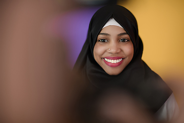 Image showing muslim woman with a beautiful smile wearing a hijab poses in the studio