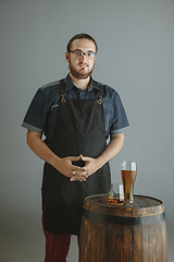Image showing Confident young male brewer with self crafted beer