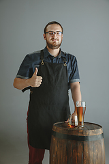 Image showing Confident young male brewer with self crafted beer