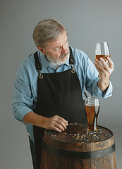 Image showing Confident senior man brewer with self crafted beer