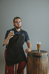 Image showing Confident young male brewer with self crafted beer