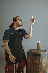 Image showing Confident young male brewer with self crafted beer