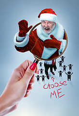 Image showing Happy Christmas Santa Claus greeting from the magnifying glass