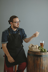 Image showing Confident young male brewer with self crafted beer