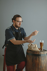 Image showing Confident young male brewer with self crafted beer