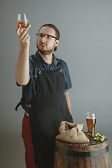 Image showing Confident young male brewer with self crafted beer