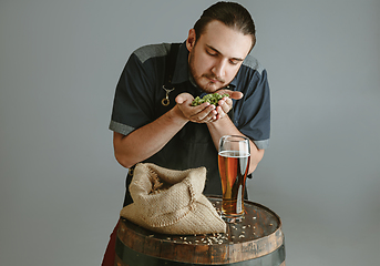 Image showing Confident young male brewer with self crafted beer