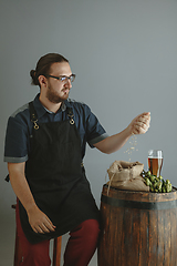 Image showing Confident young male brewer with self crafted beer