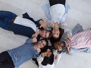 Image showing top view of a diverse group of people lying on the floor and symbolizing togetherness