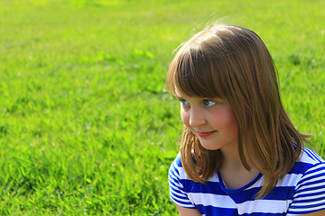 Image showing portrait of girl on the green grass background