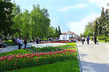 Image showing People have a rest in city park with tulips