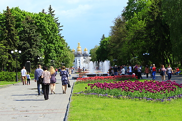 Image showing People have a rest in city park with tulips