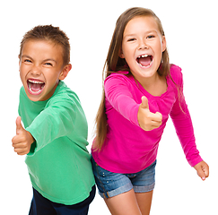 Image showing Little boy and girl are showing thumb up sign