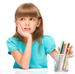 Image showing Little girl with color pencils