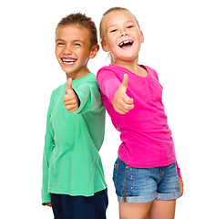 Image showing Little boy and girl are showing thumb up sign