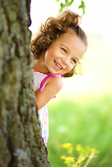 Image showing Cute little girl is playing hide and seek