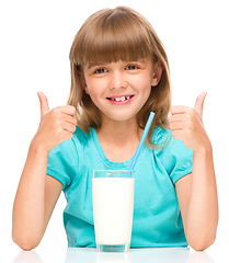 Image showing Cute little girl with a glass of milk