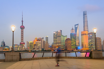 Image showing Jogging man, illuminated Shanghai cityscape