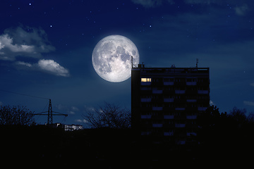 Image showing full moon over a modern building