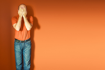 Image showing man in front of an orange wall