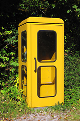 Image showing vintage yellow german phone box