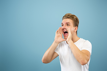 Image showing Caucasian young man\'s half-length portrait on blue background