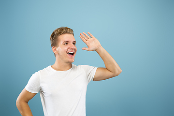 Image showing Caucasian young man\'s half-length portrait on blue background