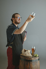 Image showing Confident young male brewer with self crafted beer