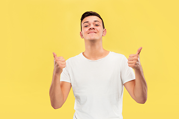 Image showing Caucasian young man\'s half-length portrait on yellow background