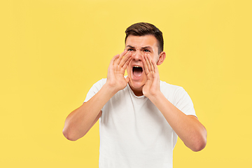 Image showing Caucasian young man\'s half-length portrait on yellow background