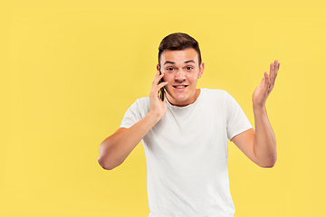 Image showing Caucasian young man\'s half-length portrait on yellow background