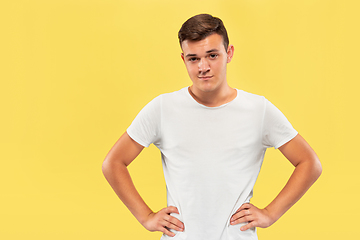 Image showing Caucasian young man\'s half-length portrait on yellow background